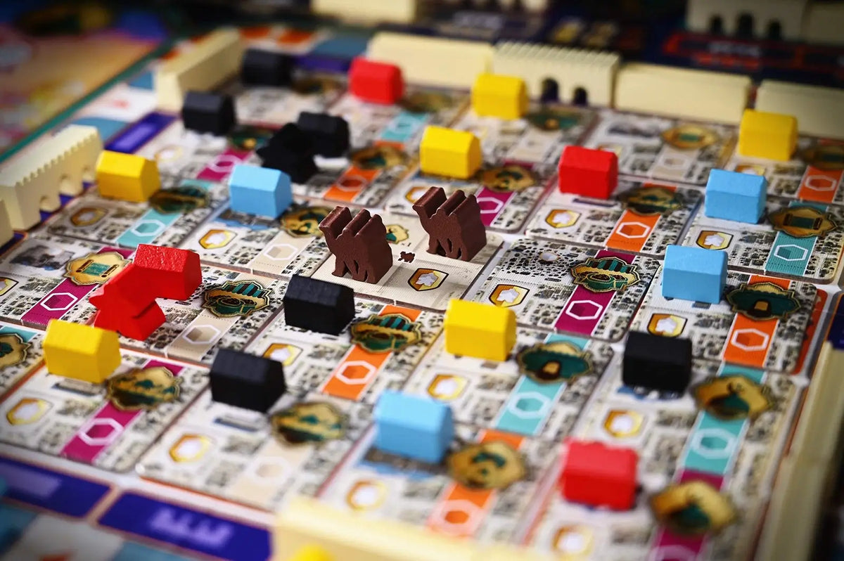 Close-up of a board game with colorful pieces on a patterned board