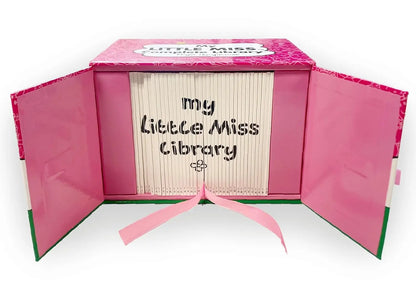 A pink hardcover book-style box labeled 'Little Miss Library' shown open, with cream-colored book pages fanned inside and the title 'my Little Miss Library' printed on the front. A pink ribbon is tied at the bottom.