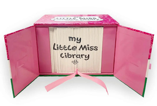 A pink hardcover book-style box labeled 'Little Miss Library' shown open, with cream-colored book pages fanned inside and the title 'my Little Miss Library' printed on the front. A pink ribbon is tied at the bottom.