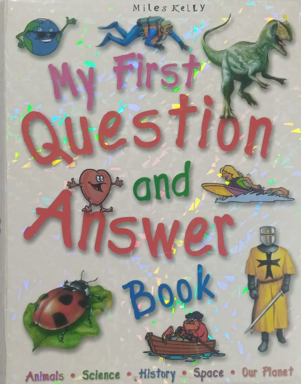 A preloved children's book titled 'My First Question and Answer Book' with illustrations of a dinosaur, a person in a space suit, and various animals on the cover.
