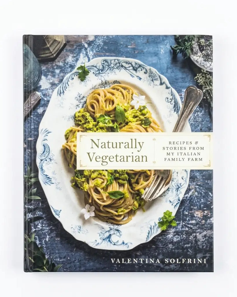 The book 'Naturally Vegetarian' by Valentina Solfrini is shown flat against a clean white background. The cover features a photograph of pasta with broccoli on a blue and white patterned plate, set against a rustic blue background.