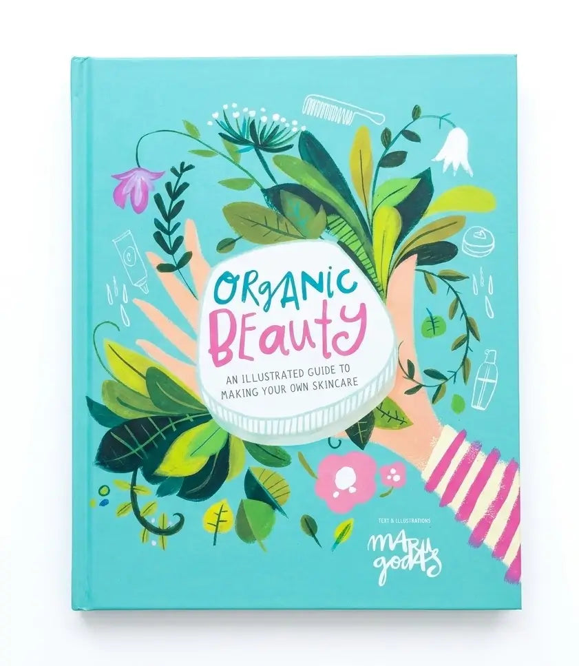 The front cover of the book 'Organic Beauty' by Maddy McGearty, featuring a bright turquoise background with colorful botanical illustrations, two hands holding a white oval label, and pink-and-white striped sleeves.