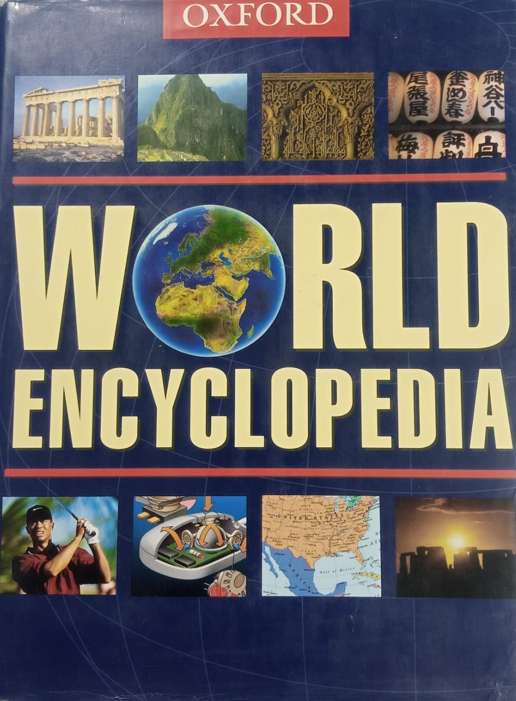 A preloved hardcover copy of the Oxford World Encyclopedia, featuring a blue cover with an image of the Earth and various cultural sites.
