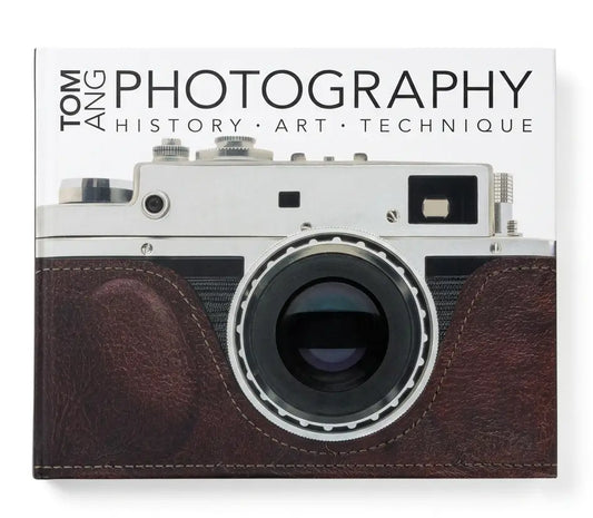 A book cover for 'Tom Ang Photography: History • Art • Technique' featuring a vintage silver and brown leather camera on a white background.