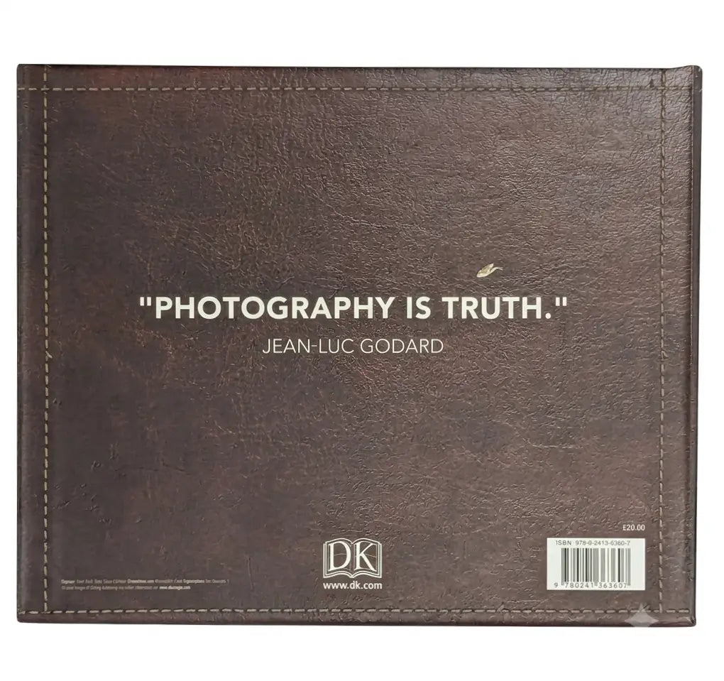 A brown faux-leather book or album cover with stitched edges, featuring the quote 'PHOTOGRAPHY IS TRUTH.' by Jean-Luc Godard in white text, with the DK logo and barcode at the bottom.