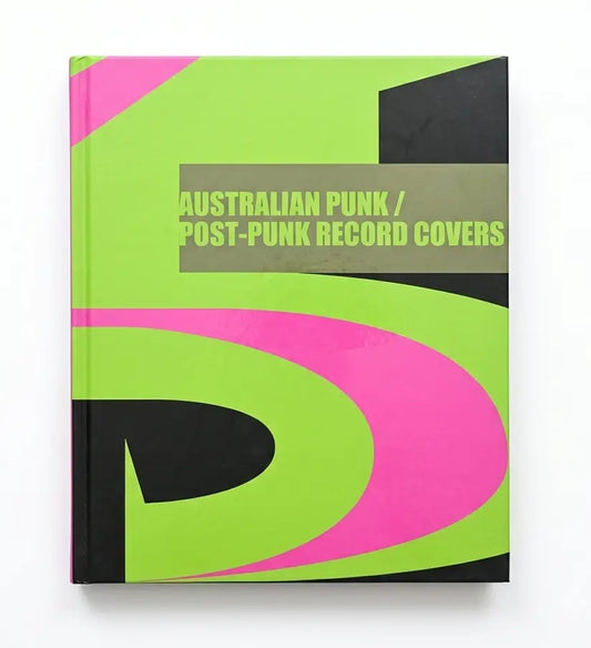 A hardcover book titled 'Australian Punk / Post-Punk Record Covers' featuring a bold abstract cover design in neon lime green, hot pink, black, and a muted taupe-brown block with white text.