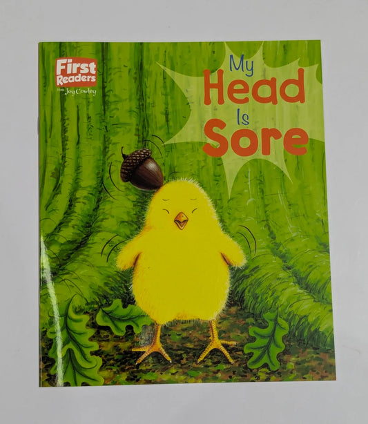 Book cover of 'My Head is Sore' with a yellow chick and acorn on a green background