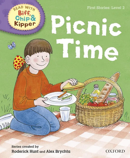 Book cover of 'Picnic Time' from the Biff, Chip & Kipper series with a child having a picnic.