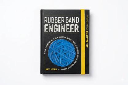 Book titled 'Rubber Band Engineer' with a blue rubber band on a white background