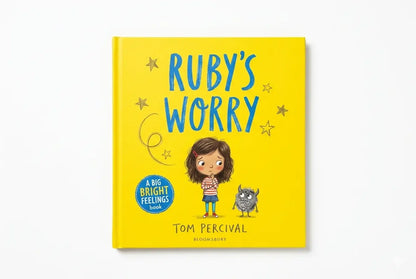 Book titled 'Ruby's Worry' with a yellow cover and illustration of a child and a worry monster on a white background.