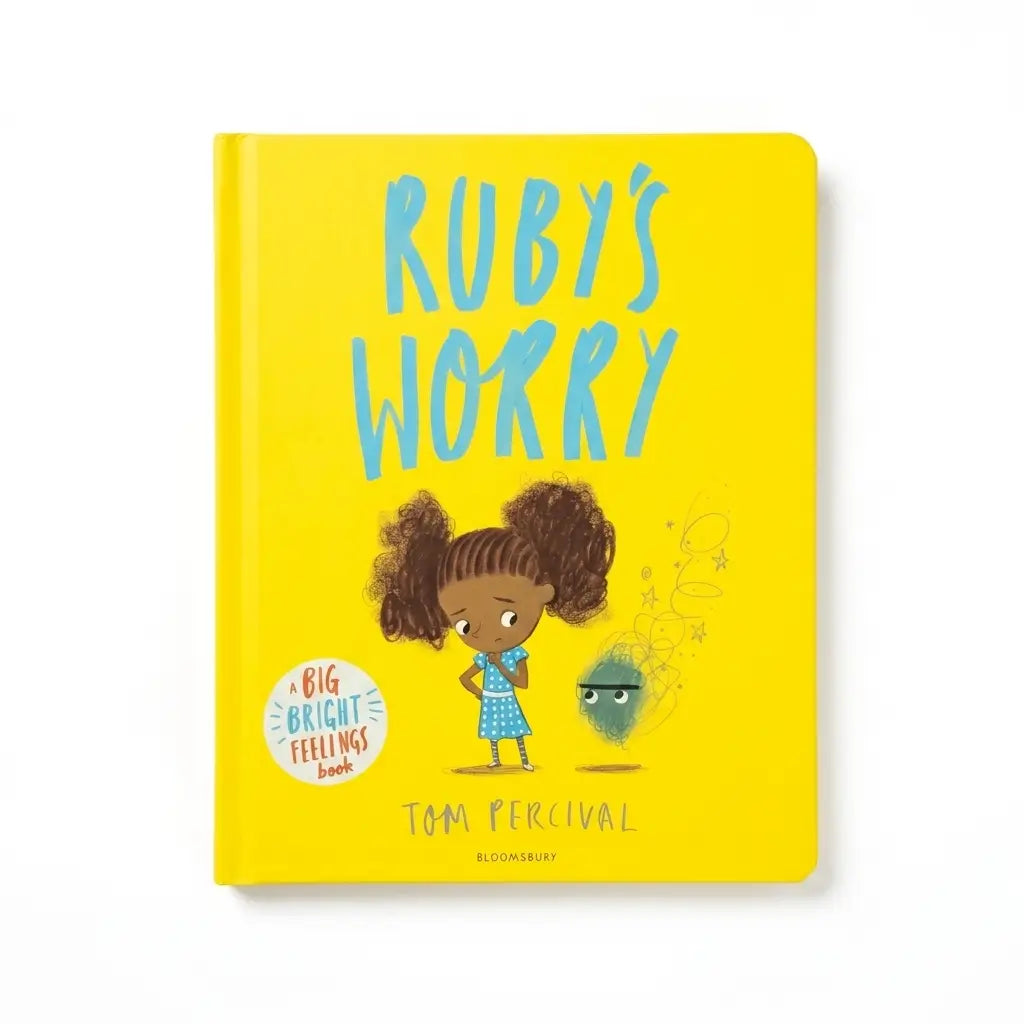 A hardcover children's book titled 'Ruby's Worry' by Tom Percival, published by Bloomsbury. The cover is bright yellow with a cartoon illustration of a girl with curly hair and a green cloud-like character, with the title in large light blue letters.