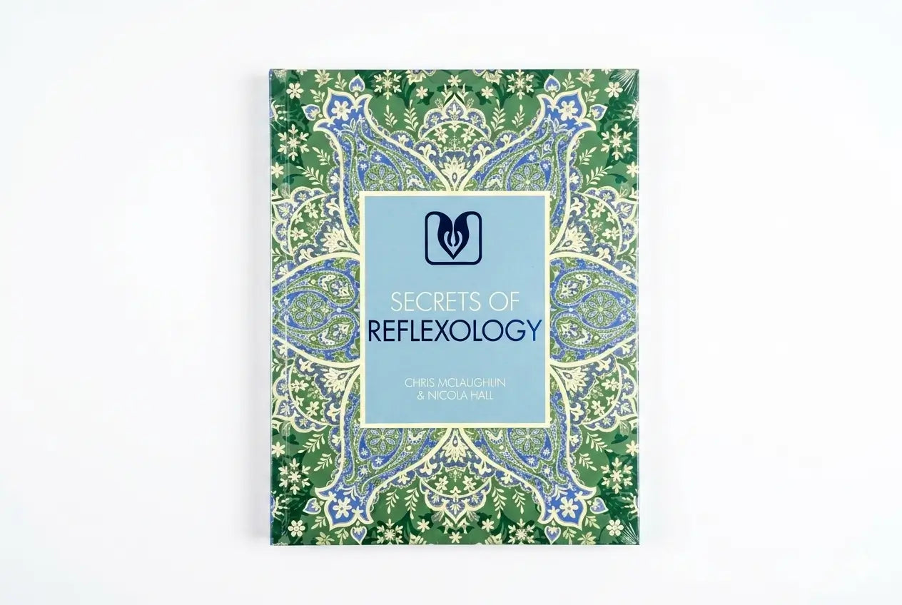 Book titled 'Secrets of Reflexology' with decorative cover on a white background