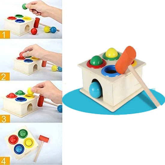 Wooden shape sorting toy with colorful balls and a hand interacting with it on a white background.