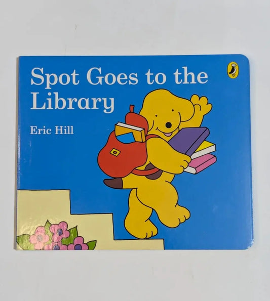 Book titled 'Spot Goes to the Library' by Eric Hill with a cartoon dog character on a blue background.