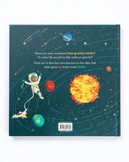 The back cover of a hardcover children's book featuring a colorful space illustration with an astronaut, planets, stars, and a large yellow-orange sun. The text on the cover reads, 'Have you ever wondered how gravity works? Or what life would be like without gravity? Find out in this fun introduction to the idea that what goes up must come down.