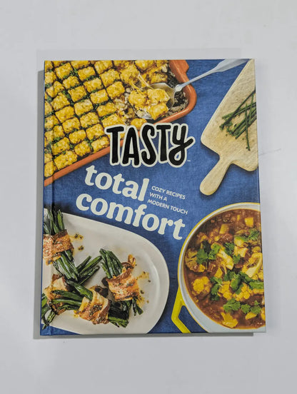 Cookbook titled 'Tasty Total Comfort' with food images on a blue background