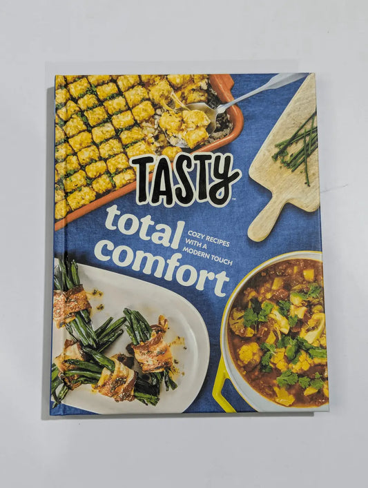Cookbook titled 'Tasty Total Comfort' with food images on a blue background