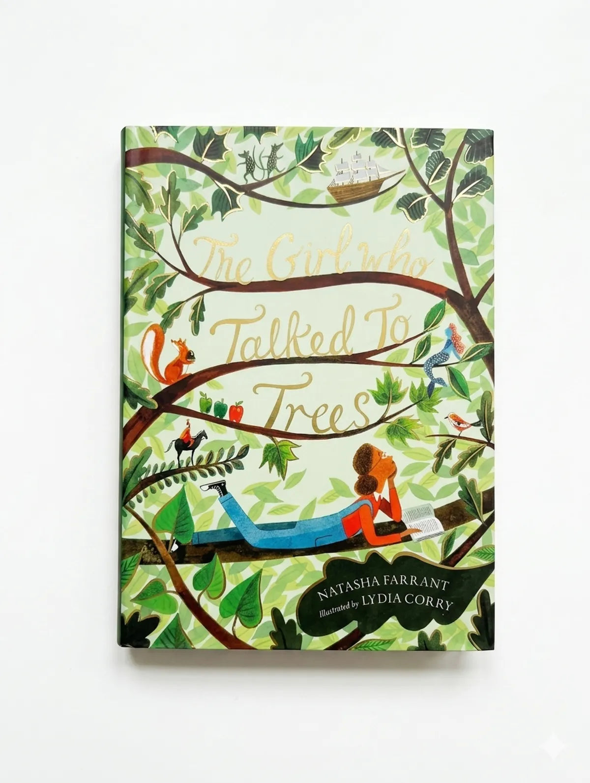 Book cover of 'The Girl Who Talked to Trees' with illustrations of a girl and trees on a white background.