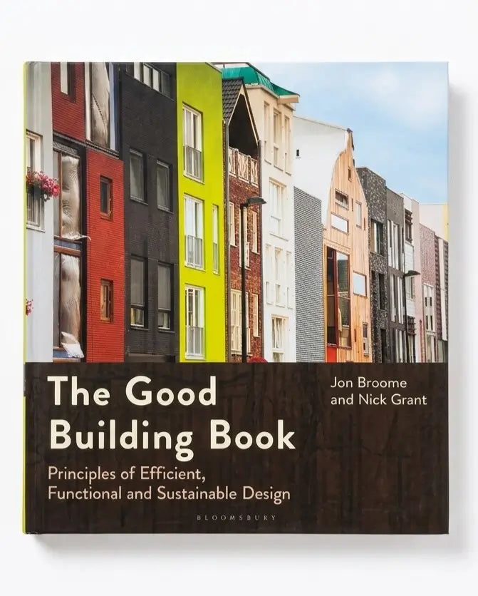 The Good Building Book by Jon Broome and Nick Grant, published by Bloomsbury. The book cover features a photograph of colorful modern buildings under a blue sky, with a dark brown lower section containing the title and authors in white text.