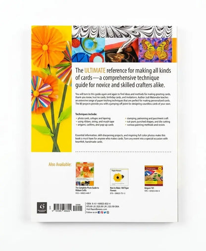 The back cover of a book titled 'The Ultimate Reference for making all kinds of cards' is shown against a white background. The cover features a colorful design with a large orange flower on the left, a black-and-white patterned card stack in the upper right, and a small multicolor illustration at the top center.