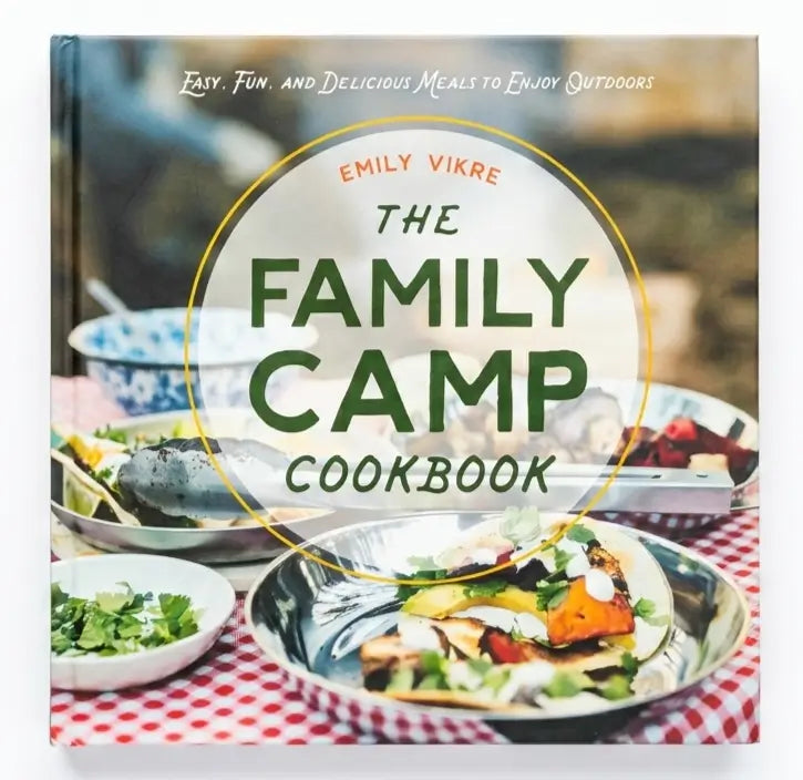 Book cover of 'The Family Camp Cookbook' by Emily Vikre with images of food on a checkered tablecloth.