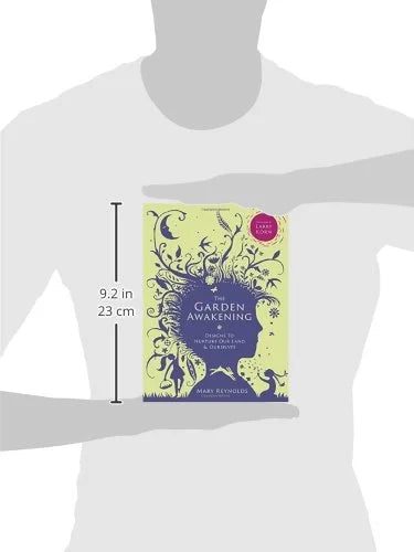 Book titled 'The Garden of Awakening' held by a person with dimensions displayed.