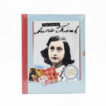 The Life of Anne Frank book set in its original shrink wrap packaging, featuring a light blue cover with a portrait of Anne Frank, a red spine, and a small pocket book accessory.