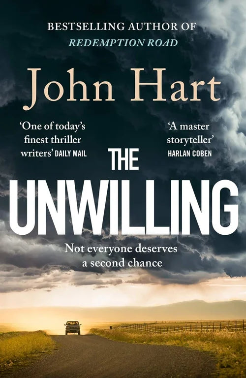 Book cover of 'The Unwilling' by John Hart with a road and stormy sky.