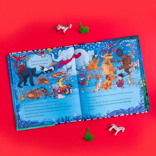 Open children's book with colorful illustrations on a red background
