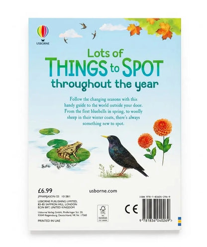 Front cover of a children's nature activity book titled 'Lots of THINGS to SPOT throughout the year' by Usborne. The cover features a light blue sky background with green title text, illustrations of a frog in a pond, a bluebird, orange flowers, and autumn leaves.