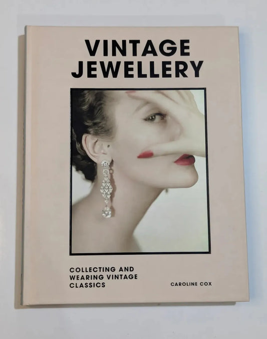 Book titled 'Vintage Jewellery' by Caroline Cox on a light background
