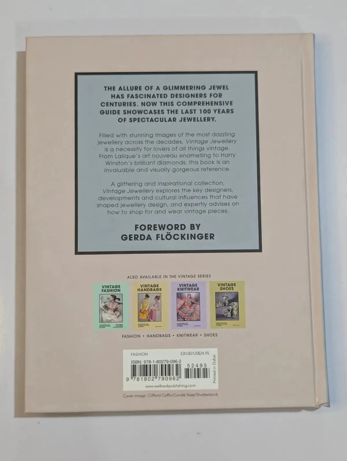 Back cover of a book with text and images of jewelry on a beige background