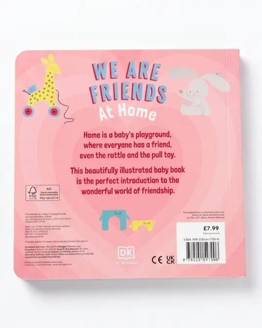 The back cover of a children's baby book titled 'WE ARE FRIENDS At Home' by DK. The cover is light pink with illustrations of a giraffe on a cart, a white bunny, and small colorful toy figures.