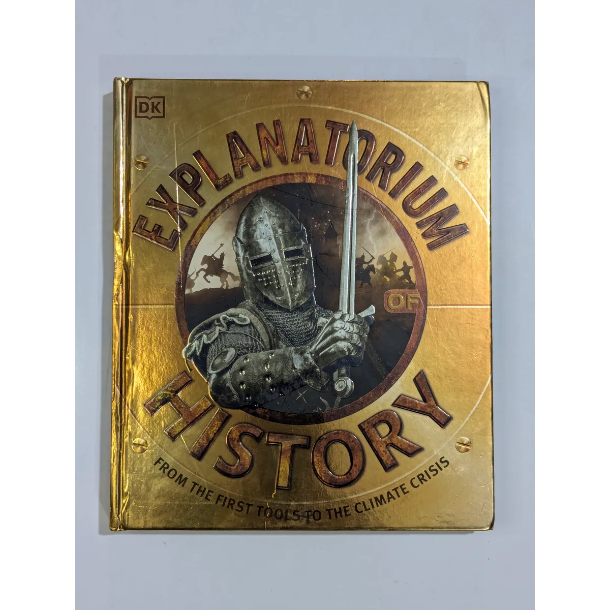 Book titled 'Explanatorium History' with a knight illustration on a gold background