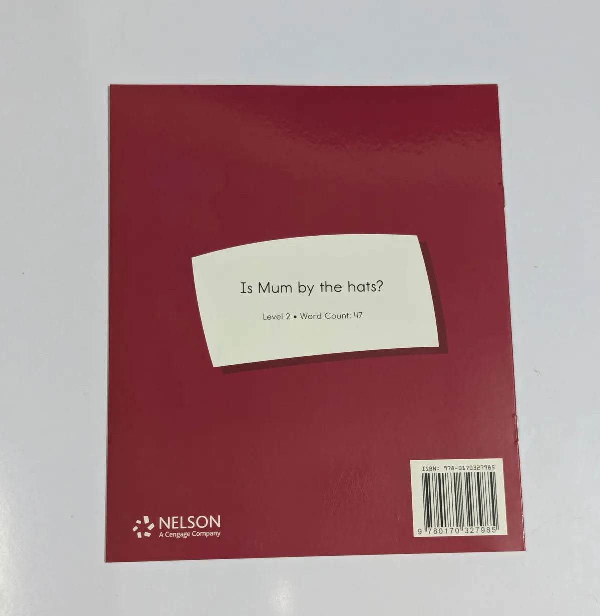 Red book cover with a white label and Nelson logo on a white background
