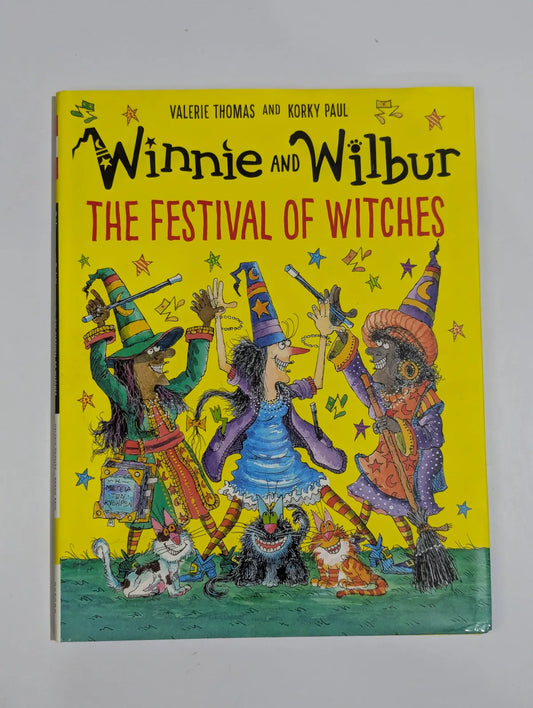 Book cover of 'Winnie and Wilbur: The Festival of Witches' with colorful illustrations on a yellow background.