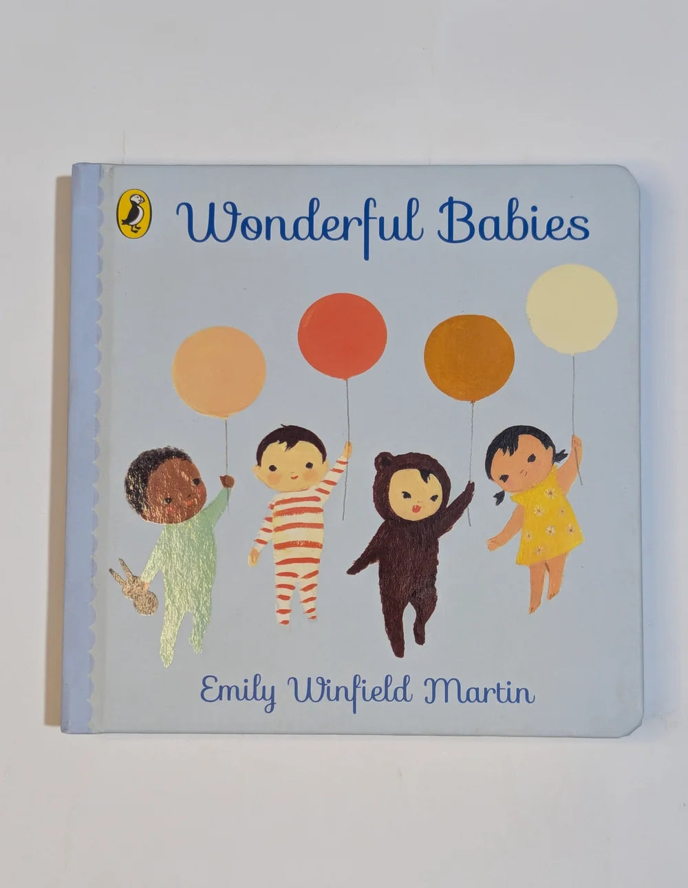 Children's book titled 'Wonderful Babies' by Emily Winfield Martin with illustrations of babies holding balloons.