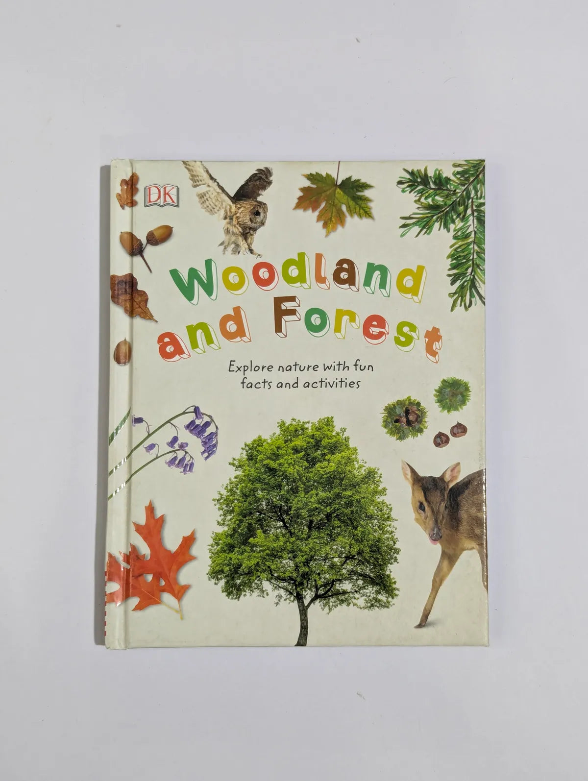 Book titled 'Woodland and Forest' with nature-themed illustrations on a white background
