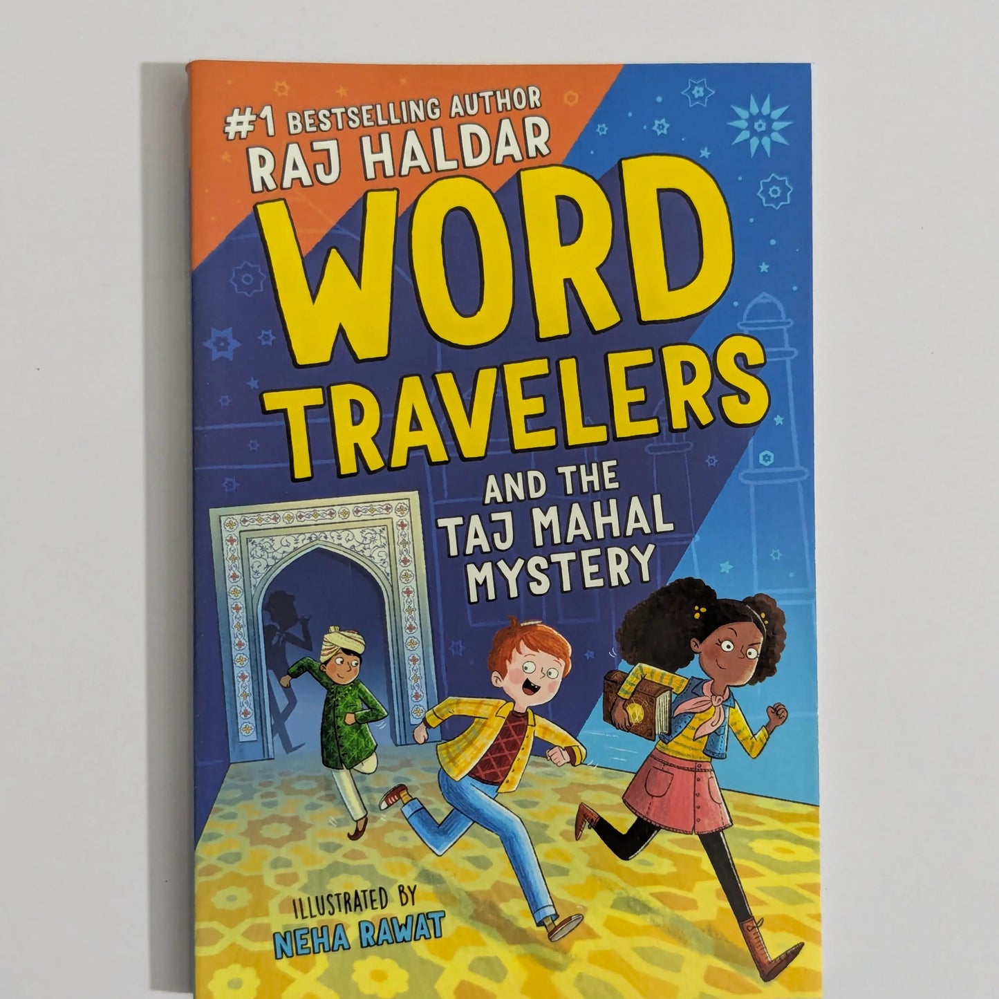 The book cover of 'Word Travelers and the Taj Mahal Mystery' by Raj Haldar, illustrated by Neha Dharmar, displayed on a neutral light gray background.